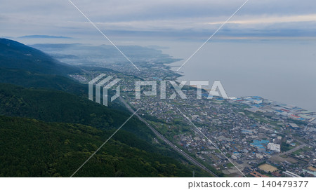 A view of the misty coastal townscape of Shikokuchuo City from the foot of the mountain. A view of the misty coastal townscape of Shikokuchuo City from the foot of the mountain. 140479377