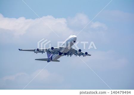 A jumbo jet begins its takeoff bound for overseas. A jumbo jet begins its takeoff bound for overseas. 140479494