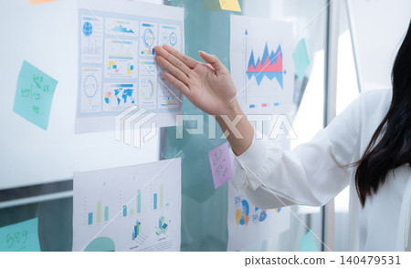Business analyst reviewing performance dashboard and financial charts during strategic planning session in a modern office. Data driven insights for growth, decision making and corporate management. Business analyst reviewing performance dashboard and financial charts during strategic planning session in a modern office. Data driven insights for growth, decision making and corporate management. 140479531