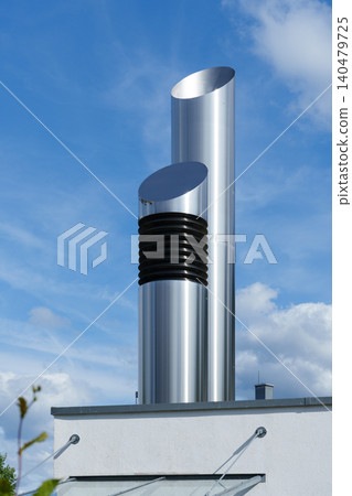 Minimalist metal chimney against blue sky 140479725