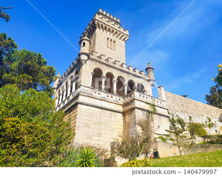 Majestic stone castle tower with elegant arches under a clear blue sky. A symbol of strength and historic European architecture, perfect for travel, heritage, or luxury lifestyle themes. Majestic stone castle tower with elegant arches under a clear blue sky. A symbol of strength and historic European architecture, perfect for travel, heritage, or luxury lifestyle themes. 140479997