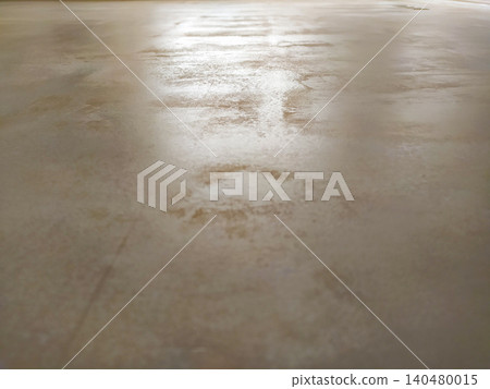 Sleek polished concrete floor texture with bright light reflections. A minimalist industrial surface background ideal for modern interior design and architectural mockups. Sleek polished concrete floor texture with bright light reflections. A minimalist industrial surface background ideal for modern interior design and architectural mockups. 140480015