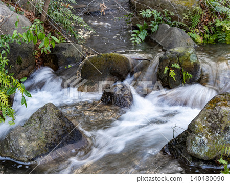 A small, pristine waterfall and clear stream in early spring A small, pristine waterfall and clear stream in early spring 140480090