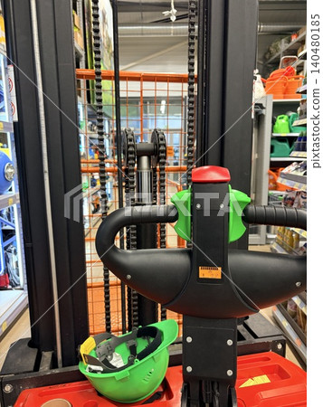 a freight elevator and a safety helmet in a hardware store a freight elevator and a safety helmet in a hardware store 140480185
