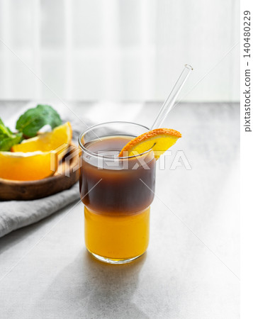 Cold bumble coffee with orange juice and ice on light background 140480229