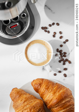 Breakfast with croissants and cappuccino from an espresso machine in a cozy, homely atmosphere. Breakfast with croissants and cappuccino from an espresso machine in a cozy, homely atmosphere. 140480243