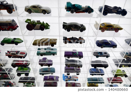 Carefully organized tiny vehicle arrangements displayed beneath glass grid ceiling with lighting Carefully organized tiny vehicle arrangements displayed beneath glass grid ceiling with lighting 140480660