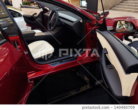 KUALA LUMUR, MALAYSIA - MARCH 15, 2026: Tesla display in shopping mall showcasing polished electric cars, large red logo sign, promotional KUALA LUMUR, MALAYSIA - MARCH 15, 2026: Tesla display in shopping mall showcasing polished electric cars, large red logo sign, promotional 140480709
