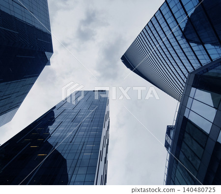 Tall glass structures ascend sharply. Multiple highrise buildings stretch towards skies 140480725