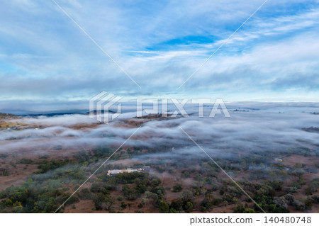 Vertical Aerial image of the scenic landscape alongside Glenbawn Dam with fog rolling through the valley in NSW Australia. Drone photograph captures rugged mountain scenery, atmospheric low cloud Vertical Aerial image of the scenic landscape alongside Glenbawn Dam with fog rolling through the valley in NSW Australia. Drone photograph captures rugged mountain scenery, atmospheric low cloud 140480748