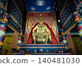 majestic, muscular golden deity sits enthroned beneath an ornate canopy, surrounded by richly detailed, multicolored tapestries and traditional embroidered banners that evoke a profound sense of 140481030