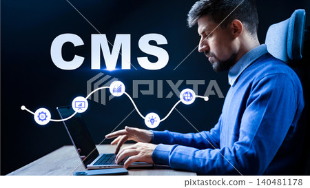 Person using a laptop to work with a content management system in a dark room Person using a laptop to work with a content management system in a dark room 140481178