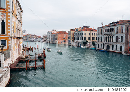 Boats travel along the Grand Canal in Venice during a cloudy afternoon Boats travel along the Grand Canal in Venice during a cloudy afternoon 140481302