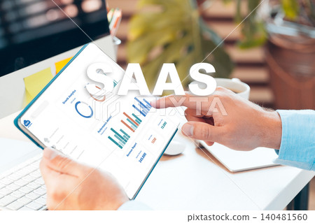 Business professional reviews SaaS data on tablet in modern office setting Business professional reviews SaaS data on tablet in modern office setting 140481560