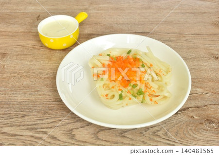 Udon or Japanese rice noodles dressing Ebiko shrimp egg dressing white cabonara onion cream sauce on plate 140481565