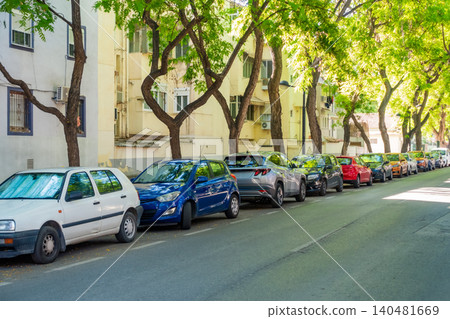 Cars Parked Along Tree Lined Residential Street in Green Neighborhood Cars Parked Along Tree Lined Residential Street in Green Neighborhood 140481669