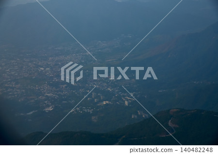 Looking from the airplane window with Hong Kong cityscape. The view of Hong Kong city, Hong Kong landscape from the above. Landscape, travel concept and nature scene. Looking from the airplane window with Hong Kong cityscape. The view of Hong Kong city, Hong Kong landscape from the above. Landscape, travel concept and nature scene. 140482248