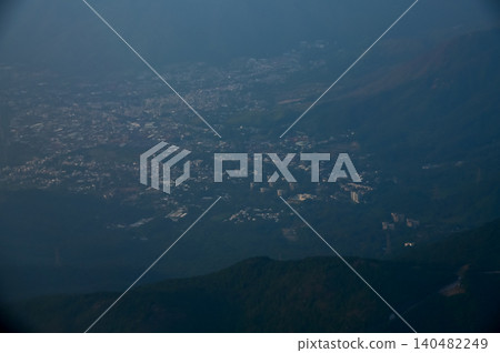 Looking from the airplane window with Hong Kong cityscape. The view of Hong Kong city, Hong Kong landscape from the above. Landscape, travel concept and nature scene. Looking from the airplane window with Hong Kong cityscape. The view of Hong Kong city, Hong Kong landscape from the above. Landscape, travel concept and nature scene. 140482249
