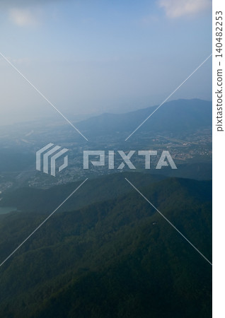Looking from the airplane window with Hong Kong cityscape. The view of Hong Kong city, Hong Kong landscape from the above. Landscape, travel concept and nature scene.  140482253