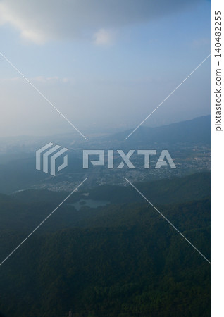 Looking from the airplane window with Hong Kong cityscape. The view of Hong Kong city, Hong Kong landscape from the above. Landscape, travel concept and nature scene.  140482255
