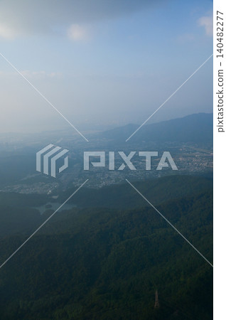 Looking from the airplane window with Hong Kong cityscape. The view of Hong Kong city, Hong Kong landscape from the above. Landscape, travel concept and nature scene. Looking from the airplane window with Hong Kong cityscape. The view of Hong Kong city, Hong Kong landscape from the above. Landscape, travel concept and nature scene. 140482277