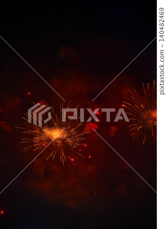 Stunning and colorful fireworks display in the night sky. Real fireworks background. Abstract of real shining fireworks against black background. Glowing fireworks show for celebration. Stunning and colorful fireworks display in the night sky. Real fireworks background. Abstract of real shining fireworks against black background. Glowing fireworks show for celebration. 140482469