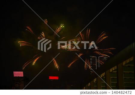 Stunning and colorful fireworks display in the night sky. Real fireworks background. Abstract of real shining fireworks against black background. Glowing fireworks show for celebration. Stunning and colorful fireworks display in the night sky. Real fireworks background. Abstract of real shining fireworks against black background. Glowing fireworks show for celebration. 140482472