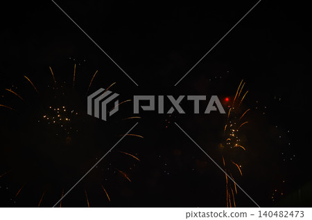 Stunning and colorful fireworks display in the night sky. Real fireworks background. Abstract of real shining fireworks against black background. Glowing fireworks show for celebration. Stunning and colorful fireworks display in the night sky. Real fireworks background. Abstract of real shining fireworks against black background. Glowing fireworks show for celebration. 140482473