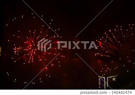 Stunning and colorful fireworks display in the night sky. Real fireworks background. Abstract of real shining fireworks against black background. Glowing fireworks show for celebration. Stunning and colorful fireworks display in the night sky. Real fireworks background. Abstract of real shining fireworks against black background. Glowing fireworks show for celebration. 140482474