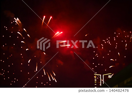 Stunning and colorful fireworks display in the night sky. Real fireworks background. Abstract of real shining fireworks against black background. Glowing fireworks show for celebration. 140482476