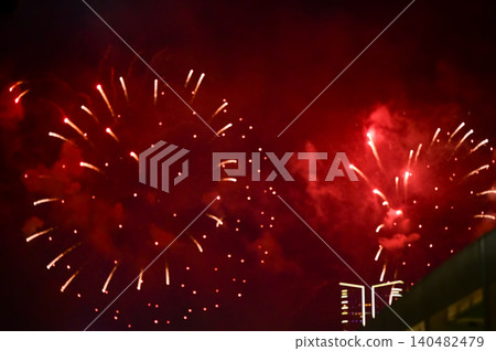 Stunning and colorful fireworks display in the night sky. Real fireworks background. Abstract of real shining fireworks against black background. Glowing fireworks show for celebration. Stunning and colorful fireworks display in the night sky. Real fireworks background. Abstract of real shining fireworks against black background. Glowing fireworks show for celebration. 140482479