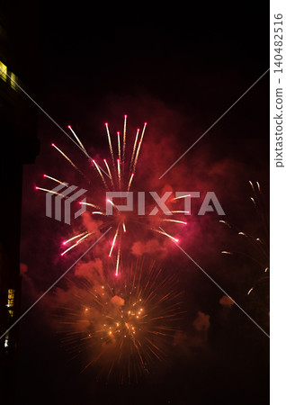 Stunning and colorful fireworks display in the night sky. Real fireworks background. Abstract of real shining fireworks against black background. Glowing fireworks show for celebration. Stunning and colorful fireworks display in the night sky. Real fireworks background. Abstract of real shining fireworks against black background. Glowing fireworks show for celebration. 140482516