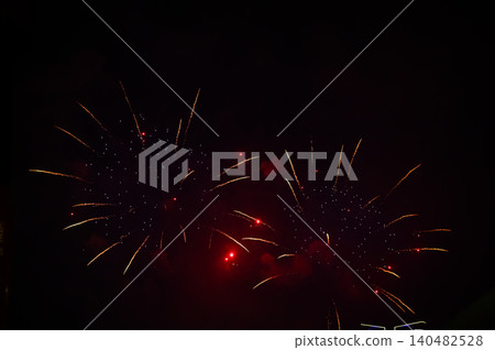 Stunning and colorful fireworks display in the night sky. Real fireworks background. Abstract of real shining fireworks against black background. Glowing fireworks show for celebration. Stunning and colorful fireworks display in the night sky. Real fireworks background. Abstract of real shining fireworks against black background. Glowing fireworks show for celebration. 140482528