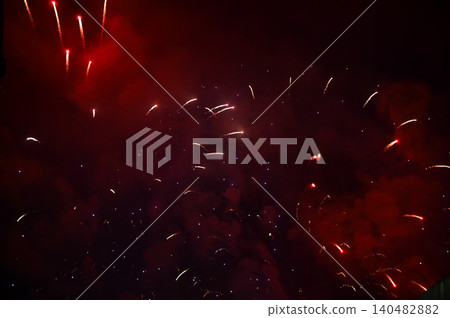 Stunning and colorful fireworks display in the night sky. Real fireworks background. Abstract of real shining fireworks against black background. Glowing fireworks show for celebration. Stunning and colorful fireworks display in the night sky. Real fireworks background. Abstract of real shining fireworks against black background. Glowing fireworks show for celebration. 140482882