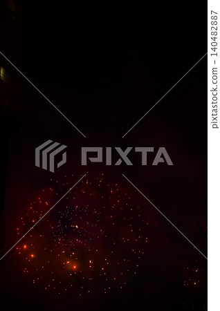 Stunning and colorful fireworks display in the night sky. Real fireworks background. Abstract of real shining fireworks against black background. Glowing fireworks show for celebration. Stunning and colorful fireworks display in the night sky. Real fireworks background. Abstract of real shining fireworks against black background. Glowing fireworks show for celebration. 140482887