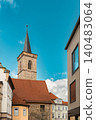 Historic Church Tower Above Red Tile Roofs 140483064
