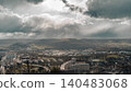 Sun Rays Breaking Through Storm Clouds Over Valley 140483068