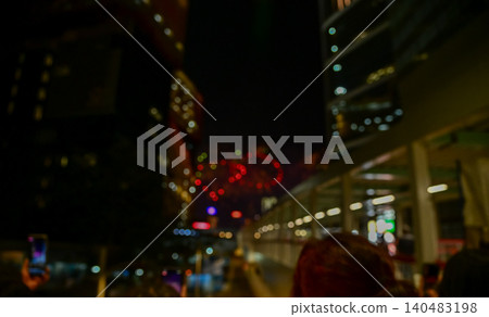 Bokeh effect of colorful fireworks display in the night sky. Real fireworks background.  Abstract of real shining fireworks against black background. Glowing fireworks show for celebration. 140483198