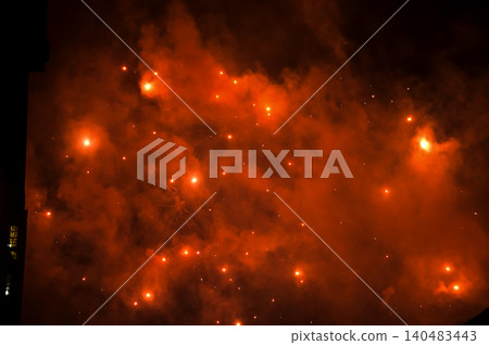 Stunning and colorful fireworks display in the night sky with smoke during explosion. Real fireworks background. Abstract of real shining fireworks against black background. for celebration. Stunning and colorful fireworks display in the night sky with smoke during explosion. Real fireworks background. Abstract of real shining fireworks against black background. for celebration. 140483443