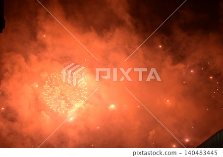 Stunning and colorful fireworks display in the night sky with smoke during explosion. Real fireworks background. Abstract of real shining fireworks against black background. for celebration. 140483445