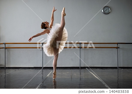 Graceful ballerina practicing in ballet class Graceful ballerina practicing in ballet class 140483838