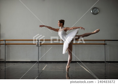 Graceful ballerina practicing in ballet class Graceful ballerina practicing in ballet class 140483872