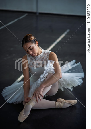 Elegant ballerina posing in ballet class Elegant ballerina posing in ballet class 140483920