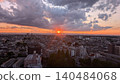 A dramatic sunset over the Okutama mountain range as seen from Musashino City (the setting sun sinking towards Mount Kumotori and the surrounding cityscape). 140484068