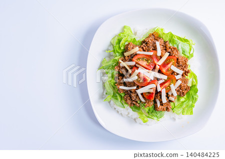 A photo of taco rice, an Okinawan dish with cheese, lettuce, and tomatoes. A photo of taco rice, an Okinawan dish with cheese, lettuce, and tomatoes. 140484225