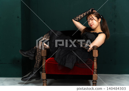 Woman in Gothic Lolita attire Woman in Gothic Lolita attire 140484303