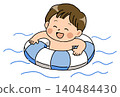 A boy with a big smile playing in the water with a swimming ring. 140484430