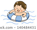 A boy with a big smile playing in the water with a swimming ring. 140484431