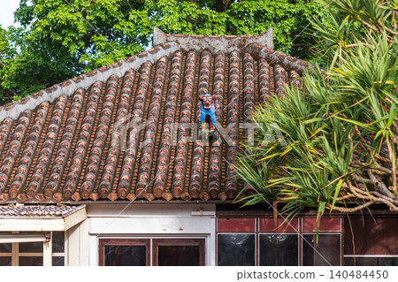 Close-up of Okinawa's traditional red-tiled buildings, colorful ceramic wind lions, guardian deities, and symbols of folk culture. Close-up of Okinawa's traditional red-tiled buildings, colorful ceramic wind lions, guardian deities, and symbols of folk culture. 140484450
