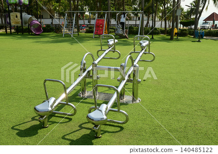 A type of ride that involves sitting and rocking back and forth in a park. A type of ride that involves sitting and rocking back and forth in a park. 140485122
